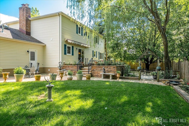 147 Smith St, South Plainfield, NJ 07080 - back of property with a patio area and a chimney