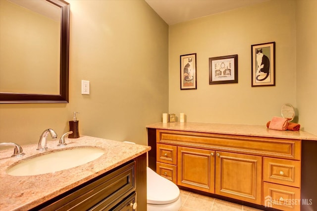 bathroom featuring tile patterned floors, toilet, and vanity