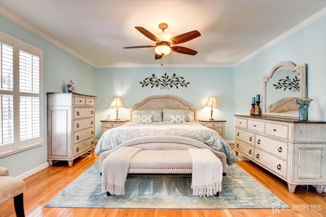 bedroom featuring crown molding, light wood-style flooring, and baseboards