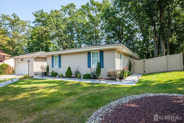 ranch-style home with a gate, a front yard, an attached garage, and fence