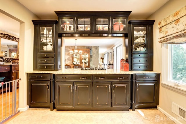 bar featuring a notable chandelier, light tile patterned floors, baseboards, and visible vents