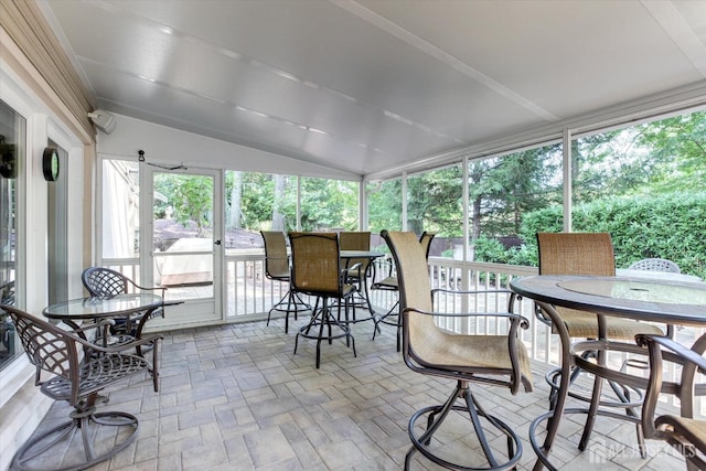 sunroom / solarium featuring lofted ceiling