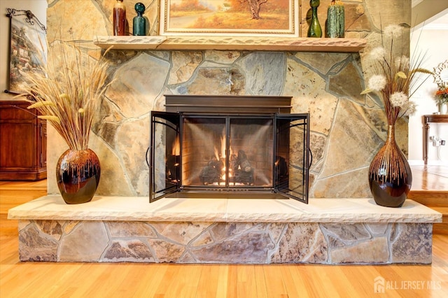 interior details featuring a fireplace and wood finished floors