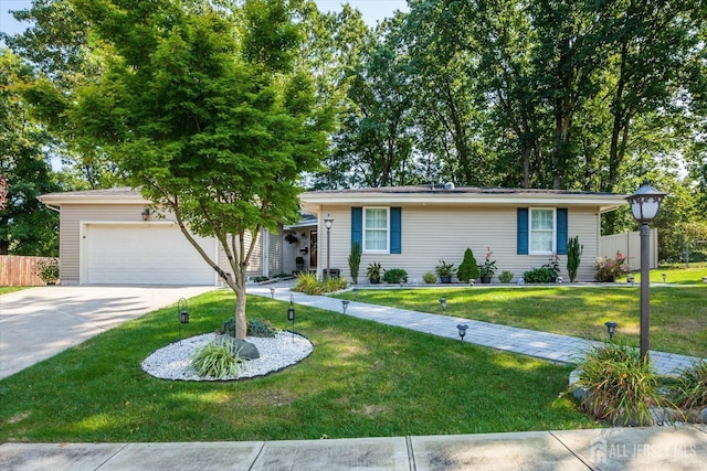 single story home featuring a front lawn, concrete driveway, a garage, and fence