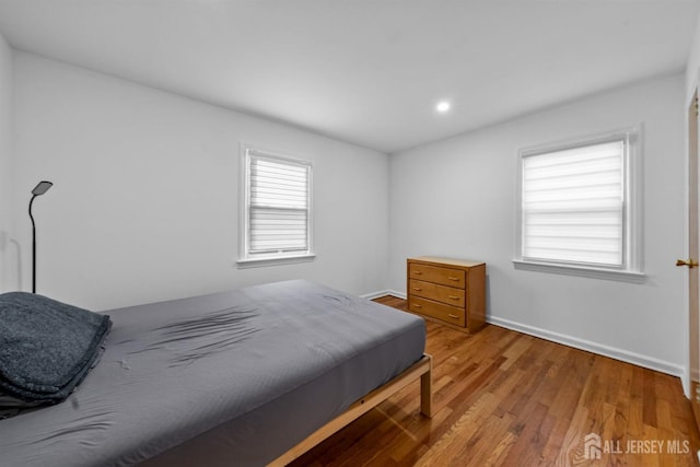 bedroom featuring baseboards and light wood-style floors