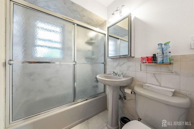 130 Cumberland St, South Plainfield, NJ 07080 - full bathroom with combined bath / shower with glass door, tile walls, and tile patterned floors