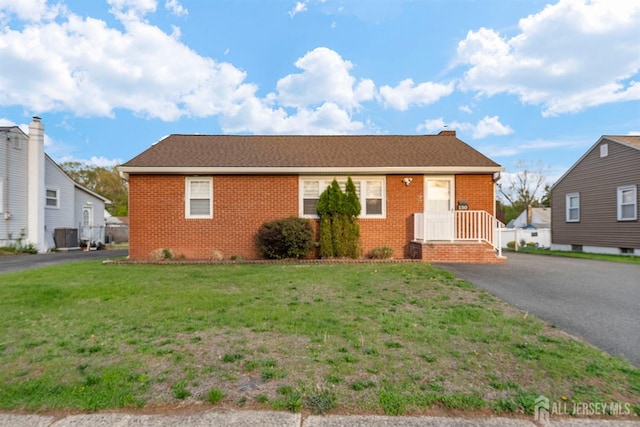 130 Cumberland St, South Plainfield, NJ 07080 - view of front of property with brick siding, a front lawn, and driveway