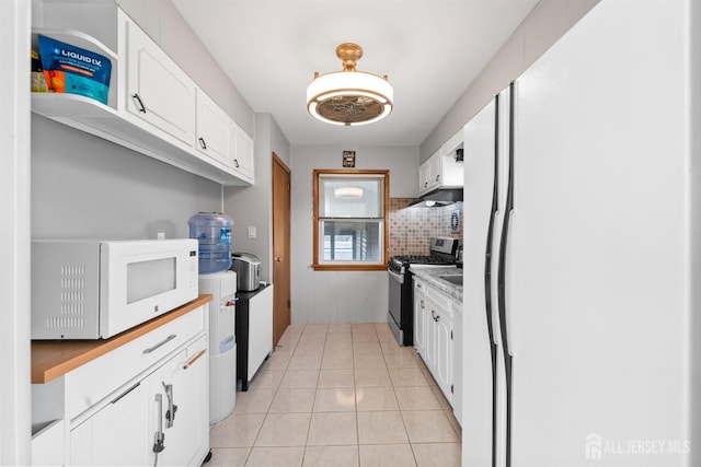kitchen featuring white appliances, light countertops, white cabinetry, backsplash, and light tile patterned floors