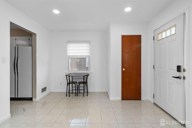 entryway with recessed lighting, baseboards, visible vents, and light tile patterned flooring