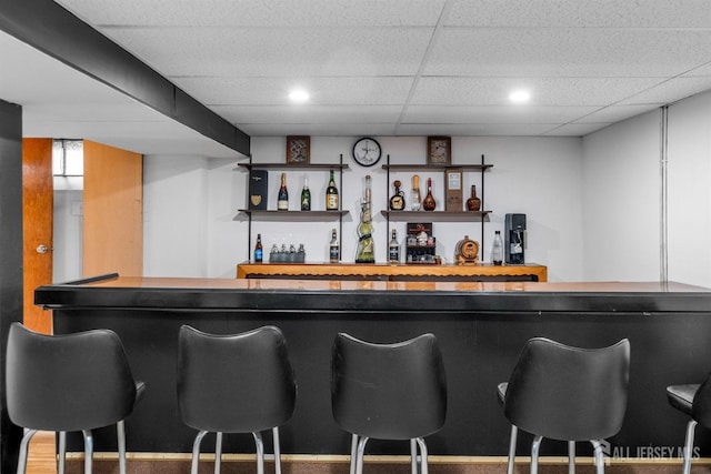 bar with a dry bar, a drop ceiling, and recessed lighting
