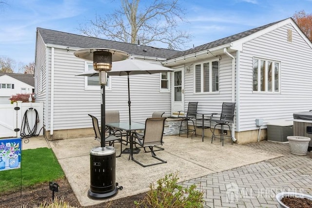 2338 Oxford Ave, South Plainfield, NJ 07080 - rear view of house with a patio, roof with shingles, and outdoor dining space