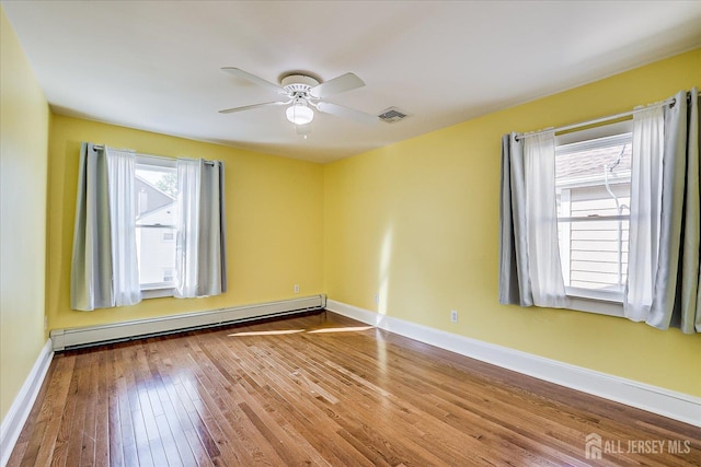 205 Midland Ave, Metuchen, NJ 08840 - empty room with a baseboard heating unit, hardwood / wood-style flooring, and a ceiling fan