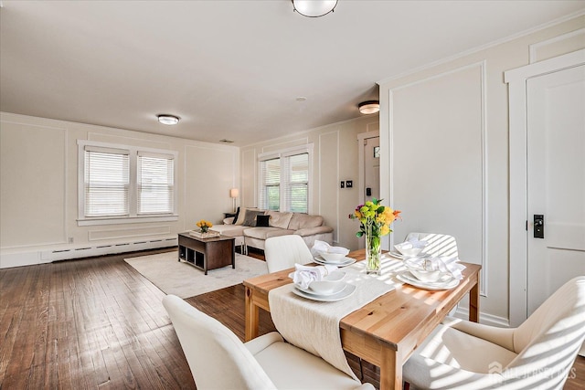 205 Midland Ave, Metuchen, NJ 08840 - dining area with baseboard heating, a decorative wall, and hardwood / wood-style floors