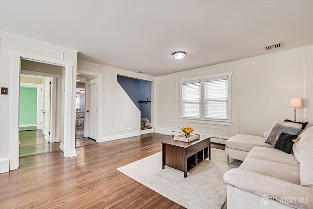 205 Midland Ave, Metuchen, NJ 08840 - living room featuring stairs, a decorative wall, and wood finished floors