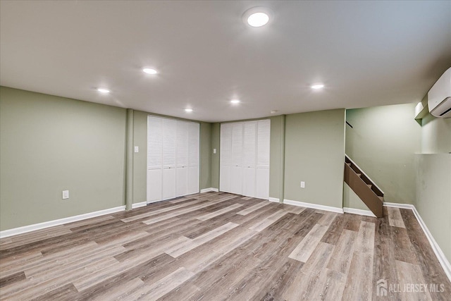 205 Midland Ave, Metuchen, NJ 08840 - finished basement featuring wood finished floors, recessed lighting, stairway, and a wall mounted AC