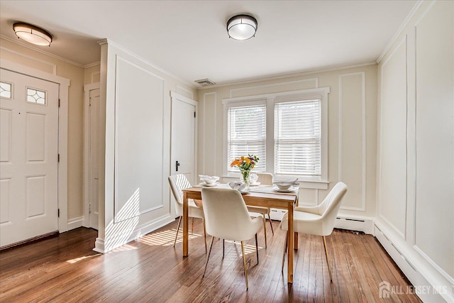 205 Midland Ave, Metuchen, NJ 08840 - dining space with a decorative wall, hardwood / wood-style floors, ornamental molding, and baseboard heating