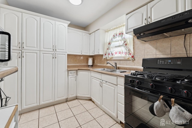kitchen with white cabinetry, black gas range oven, light tile patterned flooring, and under cabinet range hood