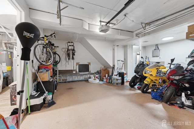 garage featuring electric panel, water heater, and a garage door opener