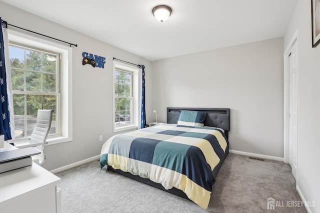 bedroom with carpet floors and baseboards