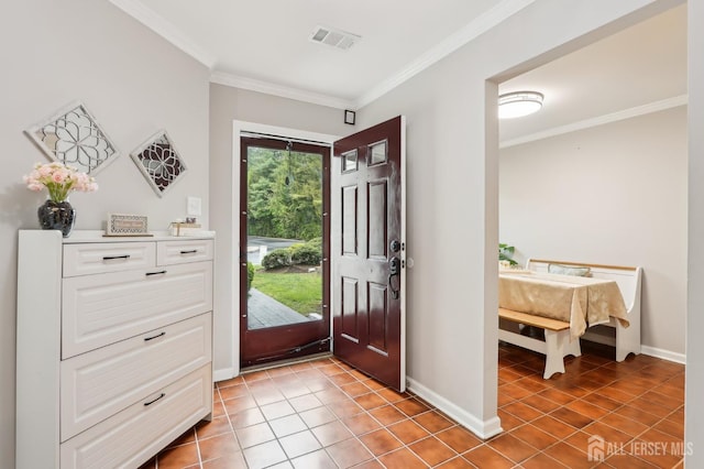 entrance foyer with baseboards, crown molding, and tile patterned flooring
