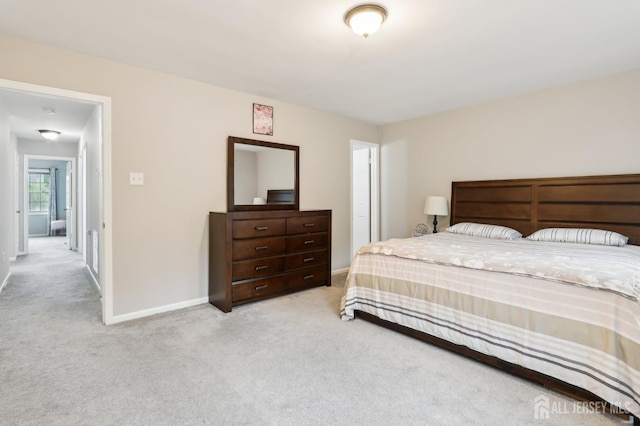 bedroom with carpet floors and baseboards