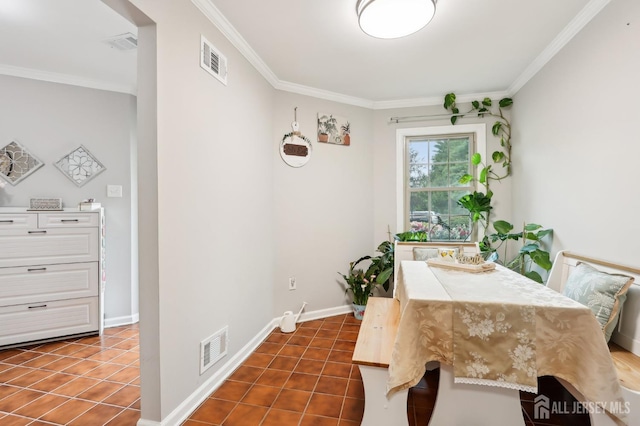 dining space with ornamental molding, dark tile patterned floors, and baseboards
