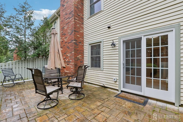view of patio / terrace featuring outdoor dining area and fence