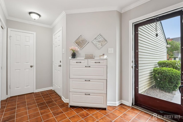 entryway featuring ornamental molding, baseboards, and dark tile patterned flooring