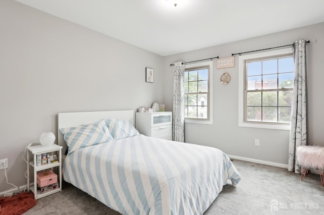 carpeted bedroom with baseboards