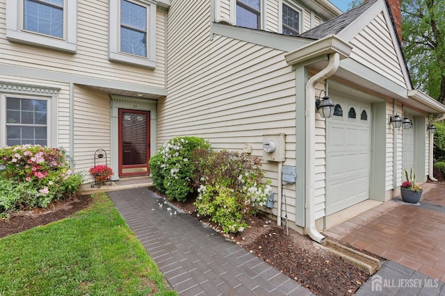 view of exterior entry with a garage