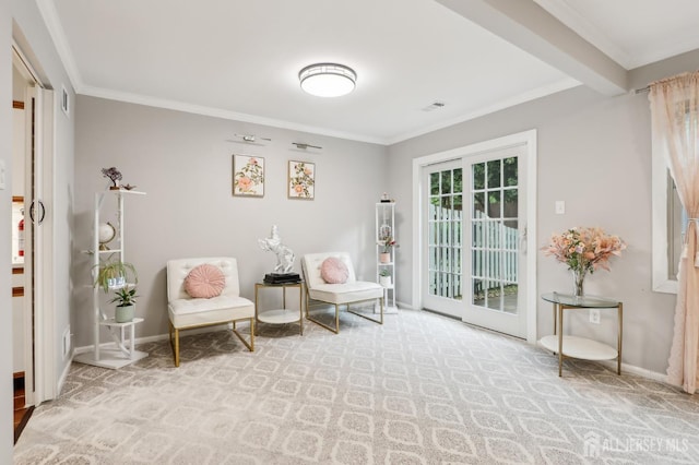 sitting room with carpet, ornamental molding, and baseboards
