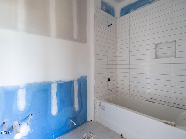 bathroom featuring tiled shower / bath combo and tile patterned floors