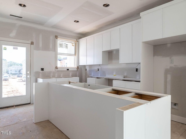 kitchen with white cabinetry and a kitchen island