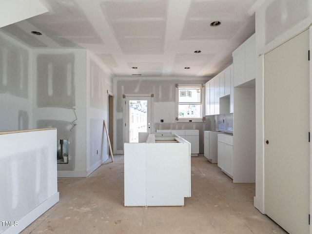 kitchen with washing machine and dryer and white cabinets