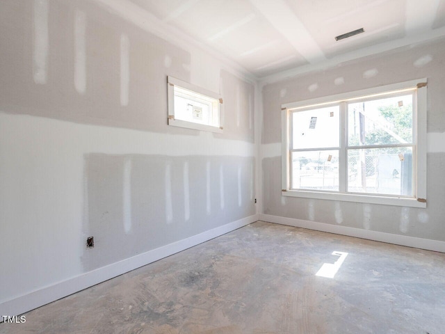 unfurnished room with concrete flooring