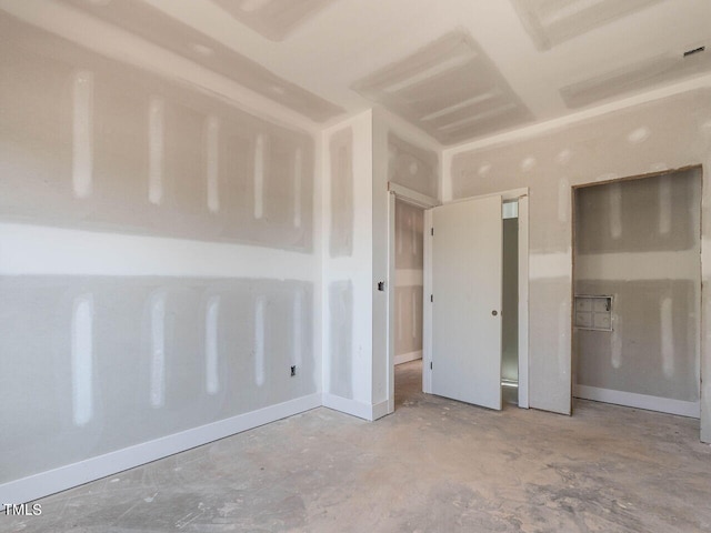 unfurnished bedroom with concrete flooring