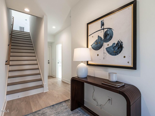 interior space with visible vents, baseboards, stairs, recessed lighting, and wood finished floors