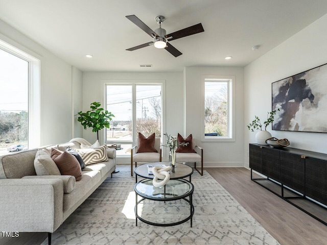 living room with wood finished floors, visible vents, baseboards, recessed lighting, and ceiling fan