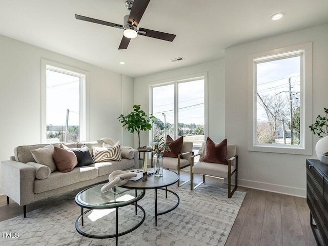 living room featuring visible vents, recessed lighting, baseboards, and wood finished floors