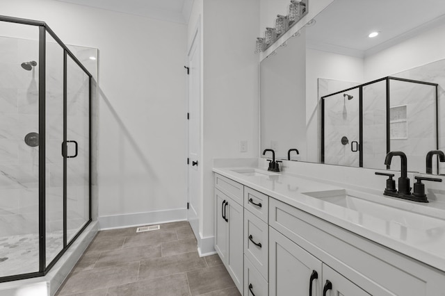 bathroom featuring tile patterned floors, a shower with door, and vanity