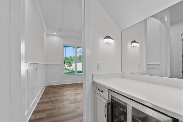 bathroom with ornamental molding, vanity, hardwood / wood-style floors, wine cooler, and lofted ceiling