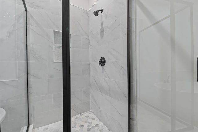 bathroom with a shower with door