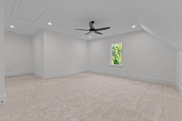 unfurnished room with ceiling fan, lofted ceiling, and light carpet