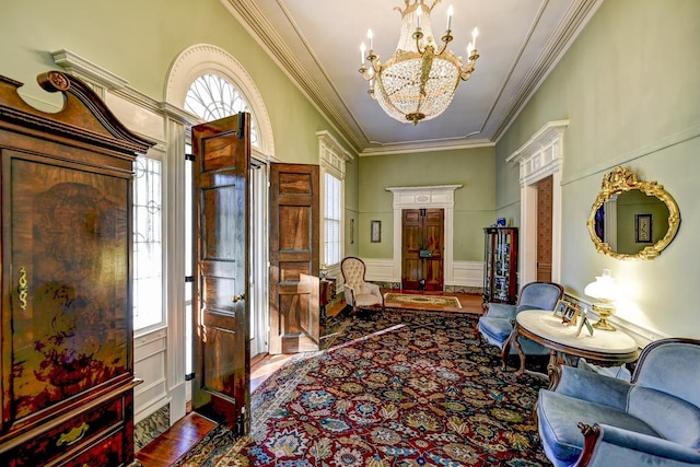 interior space featuring a notable chandelier, ornamental molding, and wood-type flooring