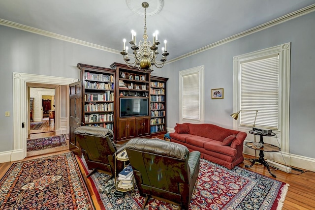 living room featuring a notable chandelier, crown molding, and light wood-type flooring