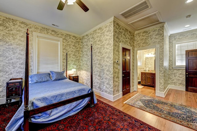 bedroom featuring ensuite bathroom, ornamental molding, ceiling fan, and light wood-type flooring