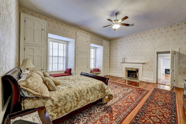 bedroom with wood-type flooring and ceiling fan