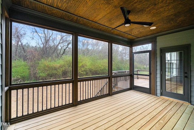 unfurnished sunroom with wood ceiling, ceiling fan, and a healthy amount of sunlight