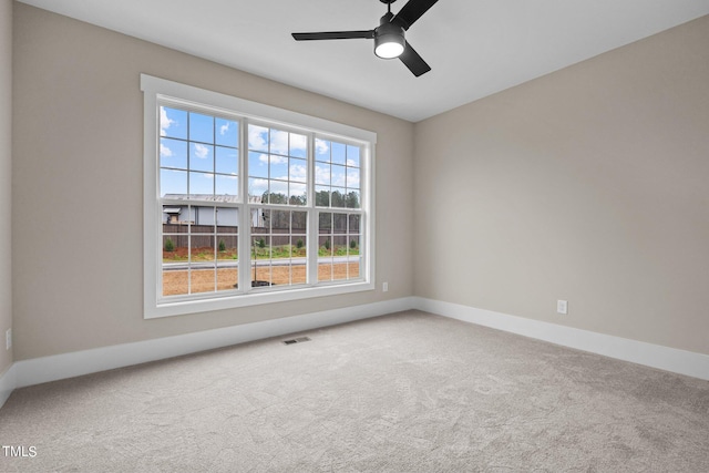 unfurnished room featuring ceiling fan and light carpet