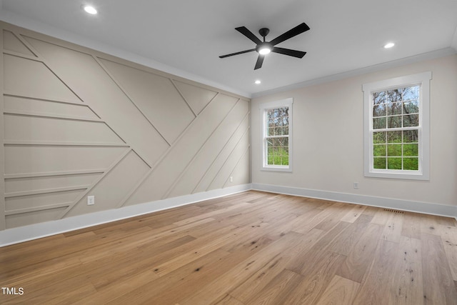 unfurnished room with plenty of natural light, light hardwood / wood-style floors, ornamental molding, and ceiling fan